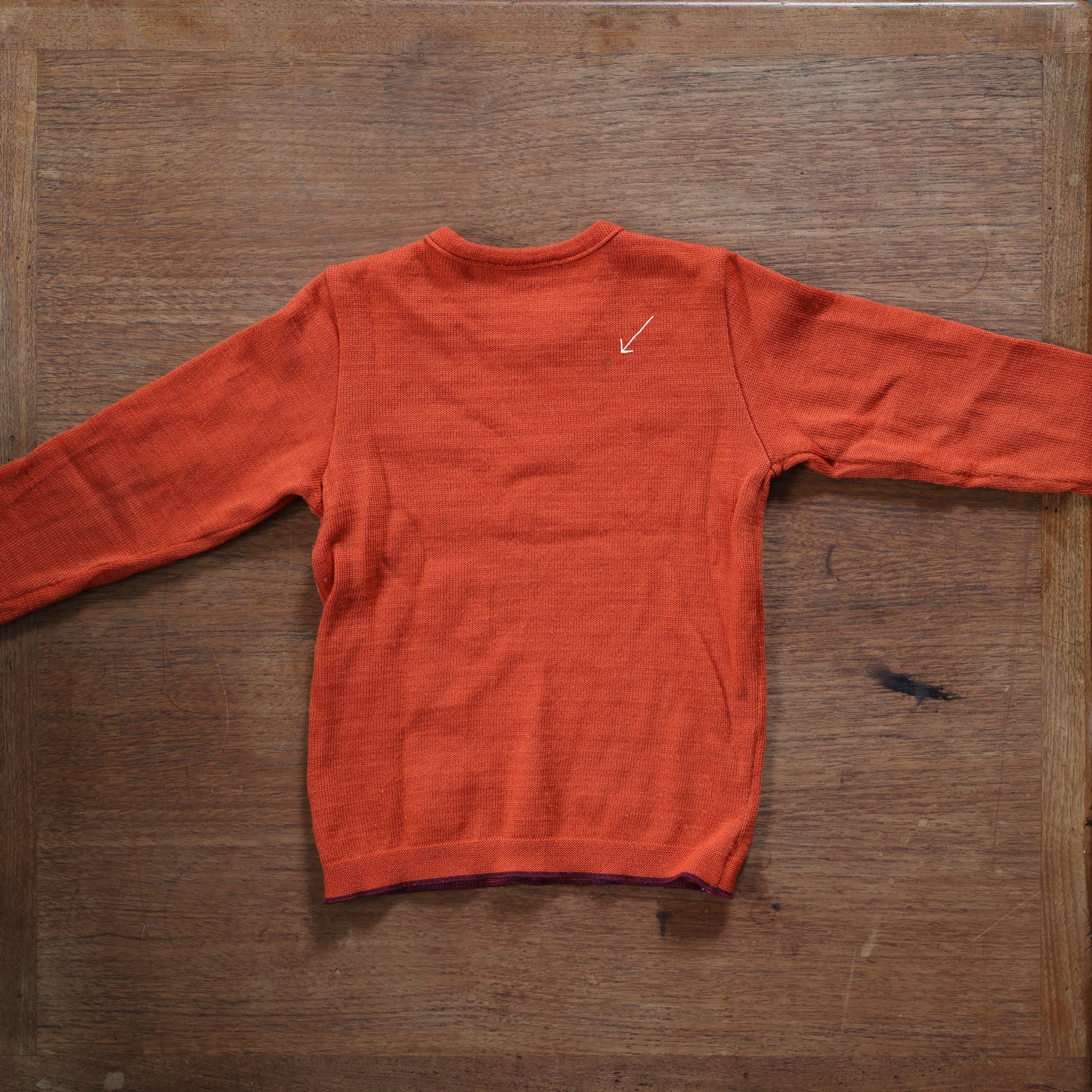 Back of Disana midweight sweater in orange showing stain