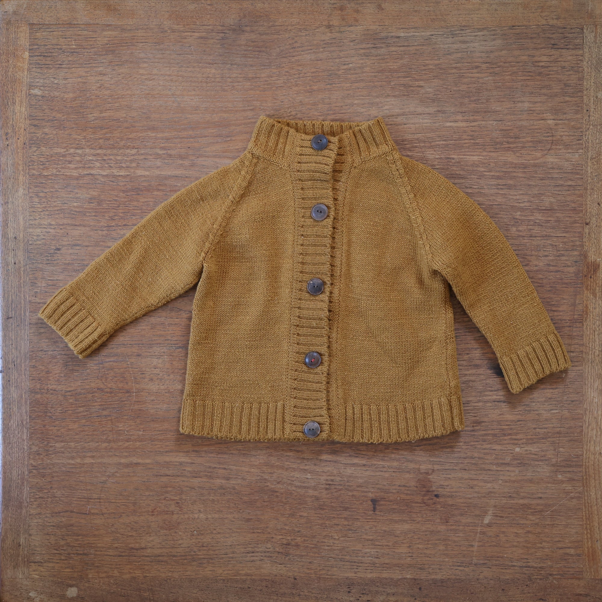 Photo of a preloved Nooks wool knit cardigan in golden spruce