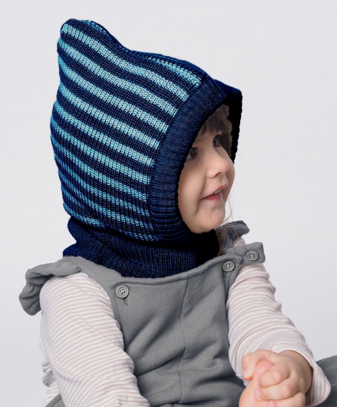 Lifestyle photo of navy-light blue striped wool balaclava.