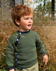 Toddler wearing a Reiff side button wool sweater in navy and apple stripe 