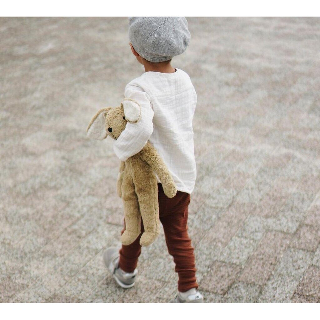 Boy holding the Large Senger organic cotton non-toxic floppy beige rabbit on a chair