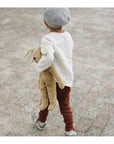 Boy holding the Large Senger organic cotton non-toxic floppy beige rabbit on a chair