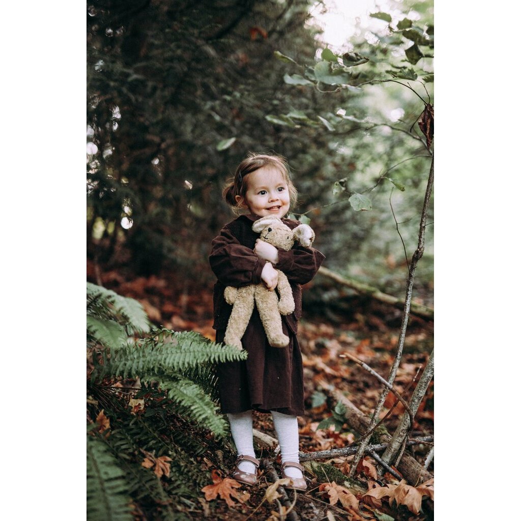 Girl holding the Large Senger organic cotton non-toxic floppy beige rabbit in a forest