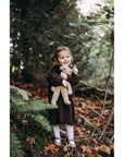 Girl holding the Large Senger organic cotton non-toxic floppy beige rabbit in a forest