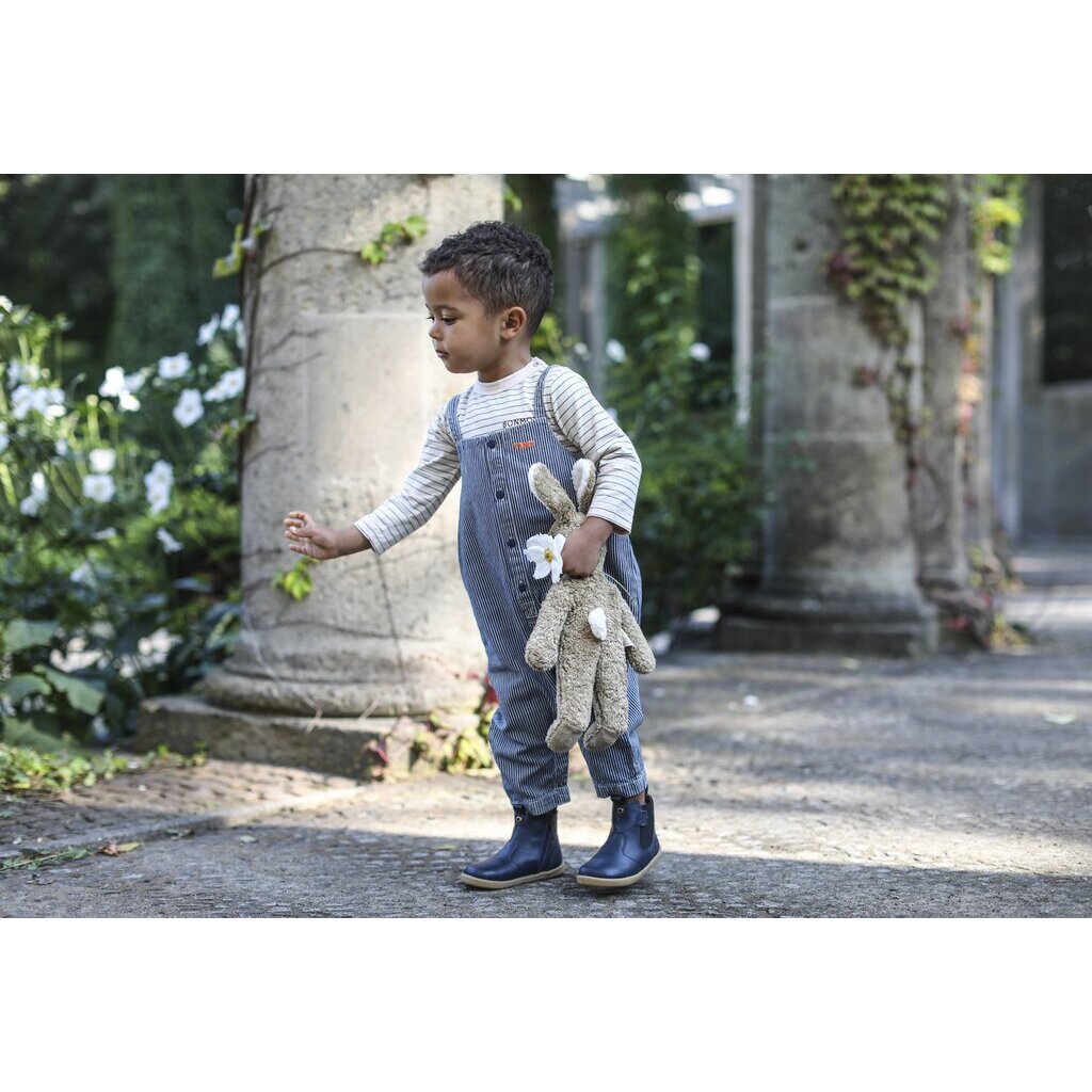 Toddler walking with a Large Senger organic cotton non-toxic floppy beige rabbit 