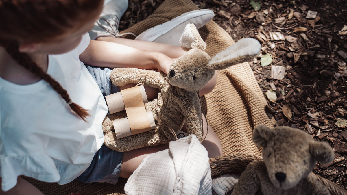 Girl holding the Large Senger organic cotton non-toxic floppy beige rabbit on her lap