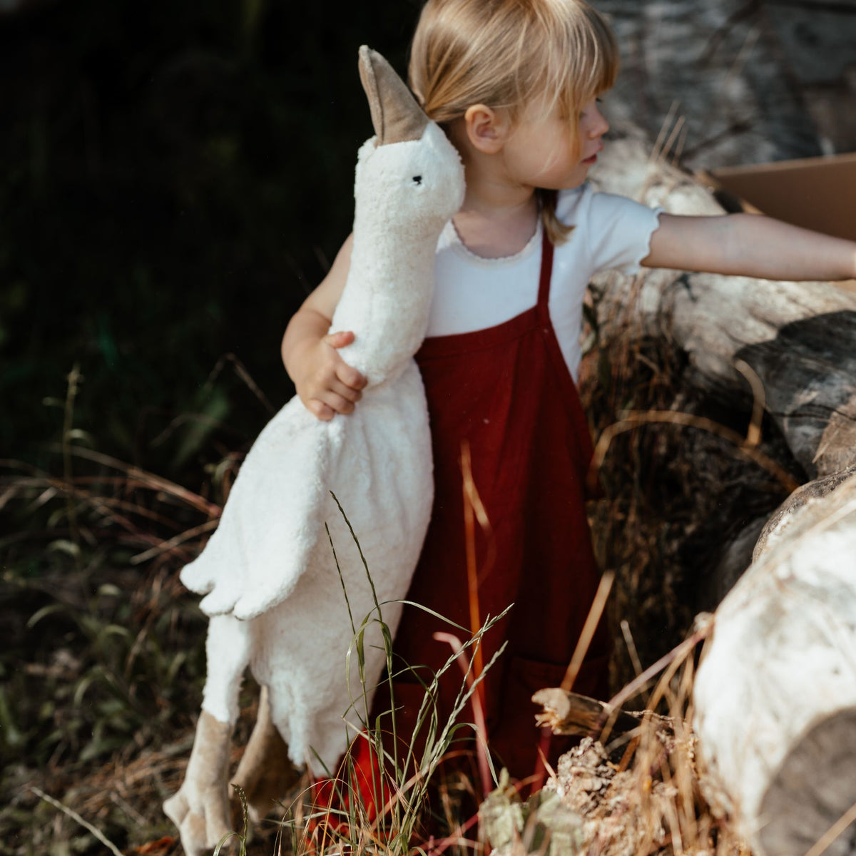 Young girl holding the Senger Cuddly large white goose made of organic cotton non-toxic materials