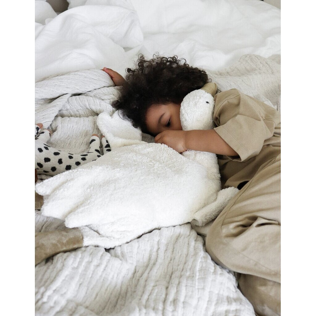 Toddler sleeping with Senger Cuddly large white goose made of organic cotton non-toxic materials