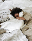 Toddler sleeping with Senger Cuddly large white goose made of organic cotton non-toxic materials