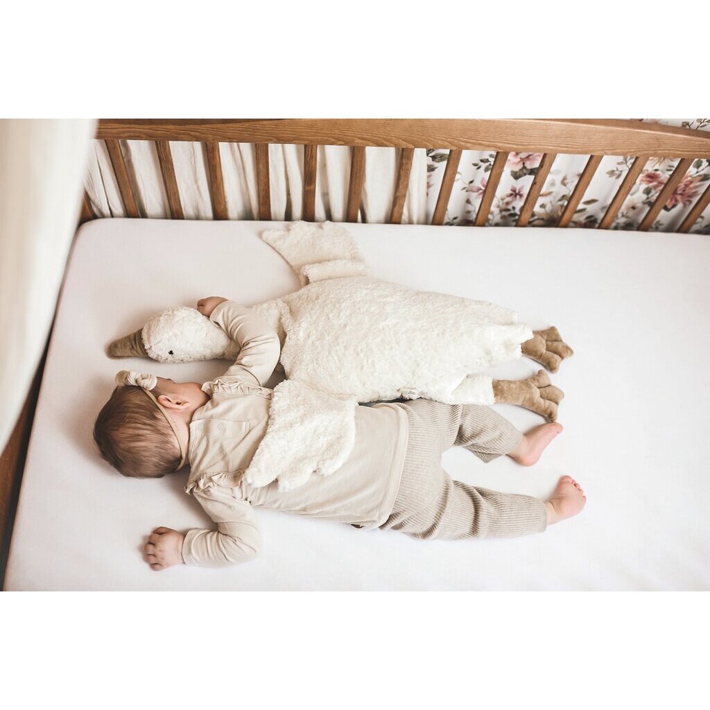 Baby sleeping with Senger Cuddly large white goose made of organic cotton non-toxic materials