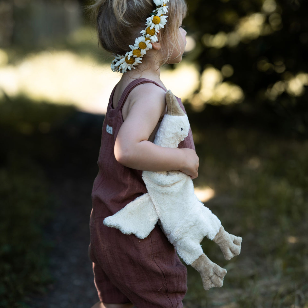 Young girl holding the small cuddly Senger organic cotton non-toxic goose
