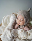 Baby sleeping next to the small cuddly Senger organic cotton non-toxic goose