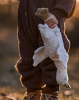 Young child holding the small cuddly Senger organic cotton non-toxic goose