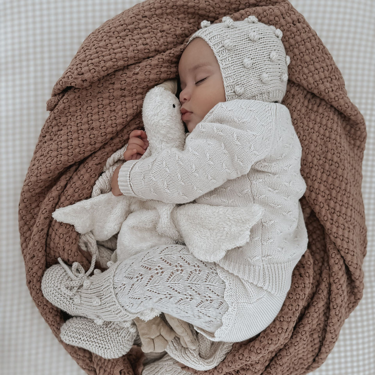 Baby sleeping with the small cuddly Senger organic cotton non-toxic goose