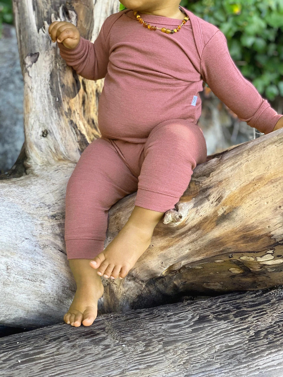 Baby in Simply Merino wool pajamas in dusky rose