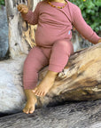 Baby in Simply Merino wool pajamas in dusky rose