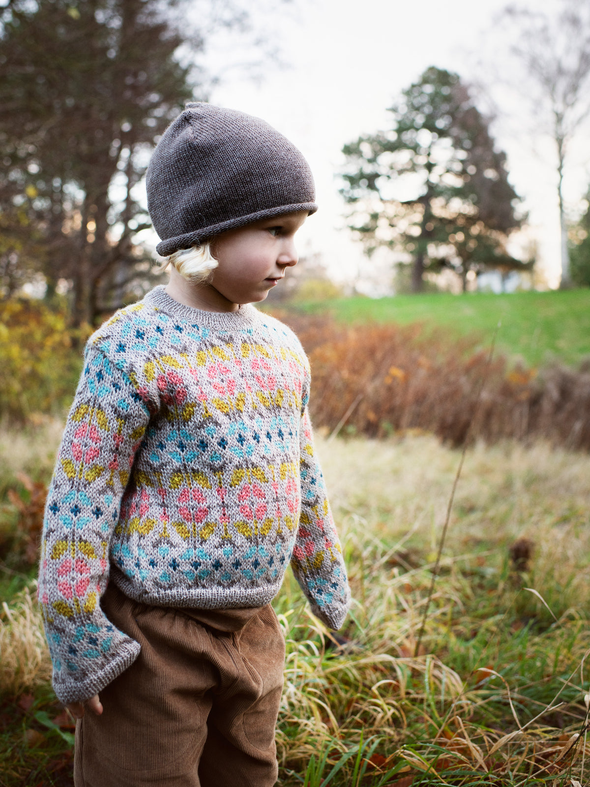 Girl wearing serendipity alpaca garden sweater with flower pattern