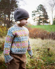 Girl wearing serendipity alpaca garden sweater with flower pattern