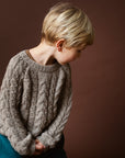 Boy wearing Serendipity Organics alpaca cable sweater in sand