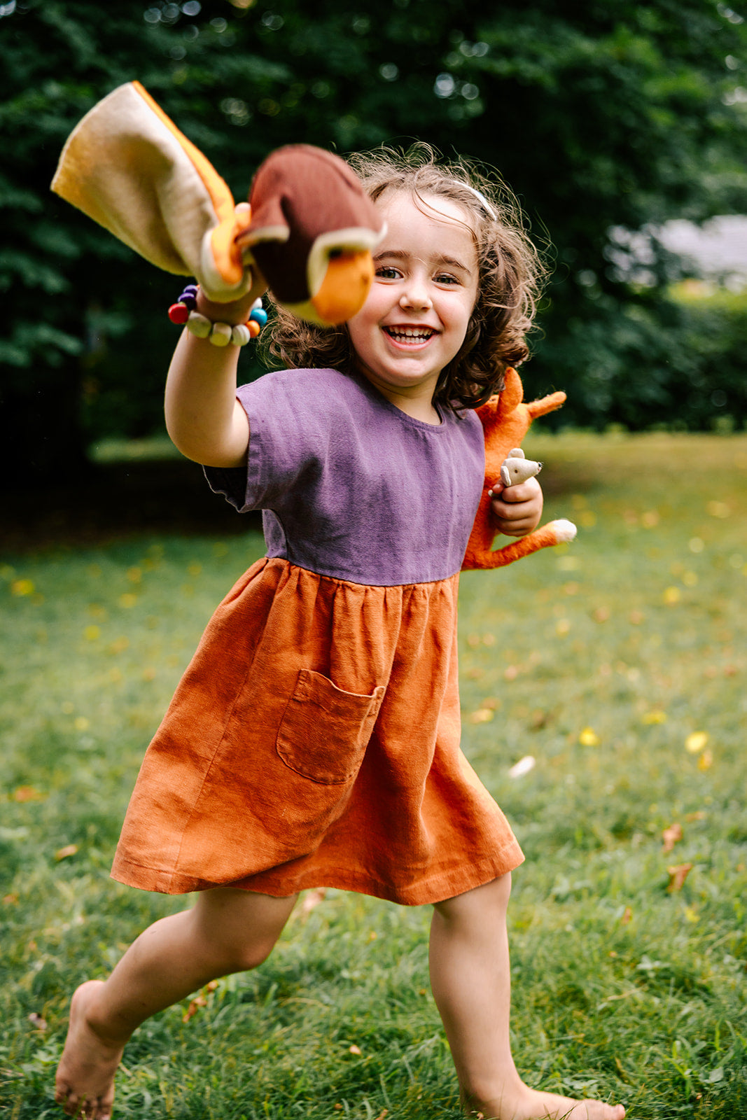 Lifestyle photo of the Bigelow Lane  linen summer dress, in two-tone purple and clay