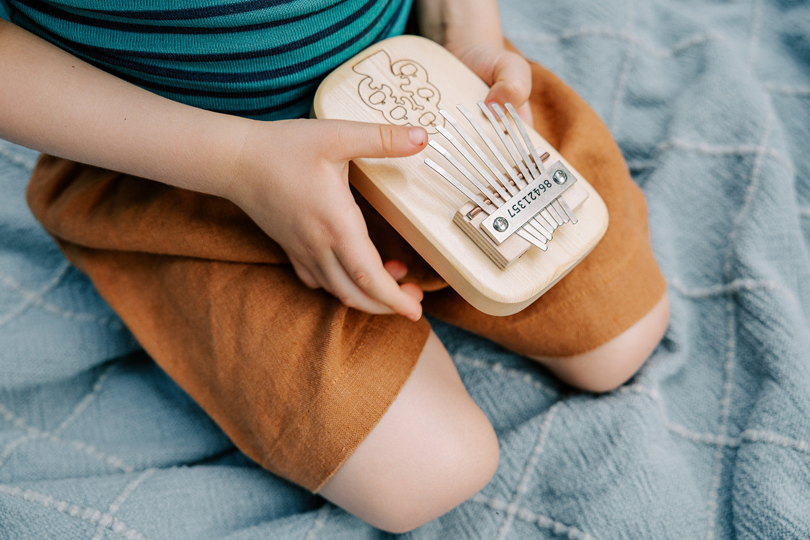 Lifestyle photo of boy sitting in linen shorts
