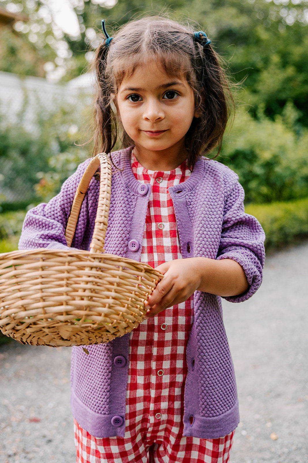 Lifestyle photo of the kids Disana honeycomb cardigan in lilac