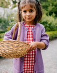 Lifestyle photo of the kids Disana honeycomb cardigan in lilac