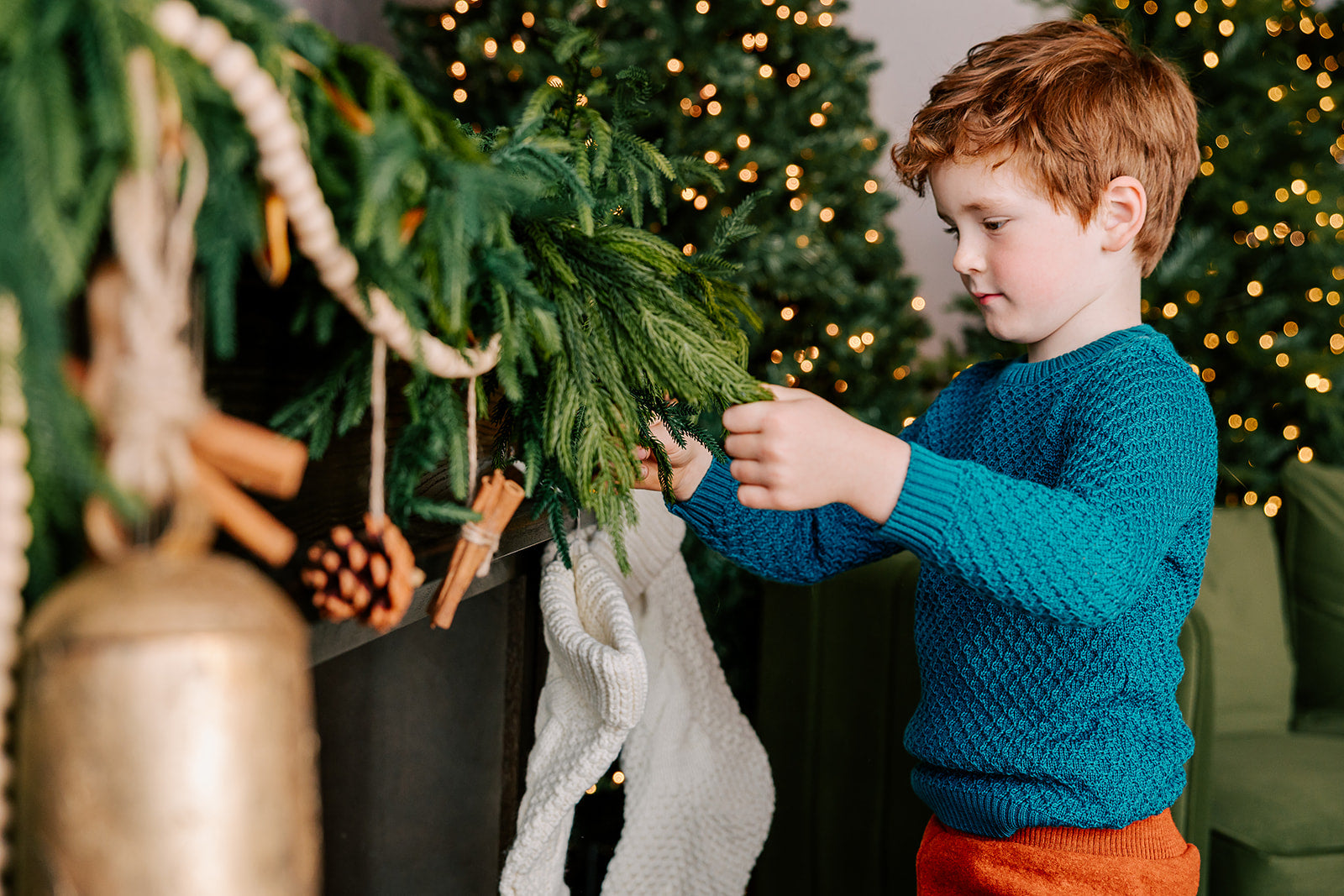 Lifestyle of child in Disana Aran wool sweater in pacific color