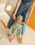Lifestyle of sleeveless linen dress in green gingham