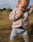 Lifestyle photo of boy in Engel wool fleece jacket in sand melange