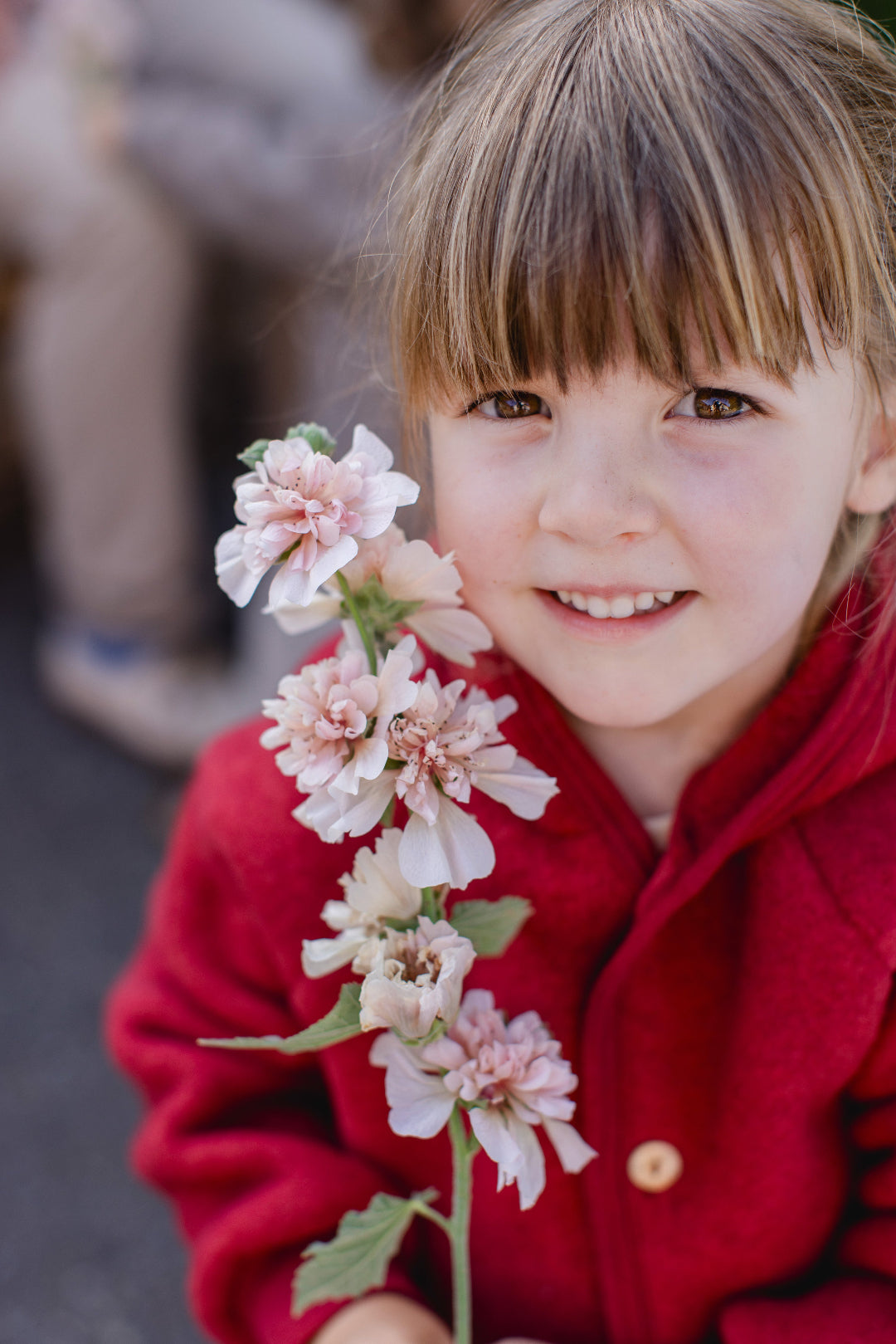 girl in Engel wool fleece hooded jacket with wooden buttons in jasper melange