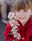 girl in Engel wool fleece hooded jacket with wooden buttons in jasper melange